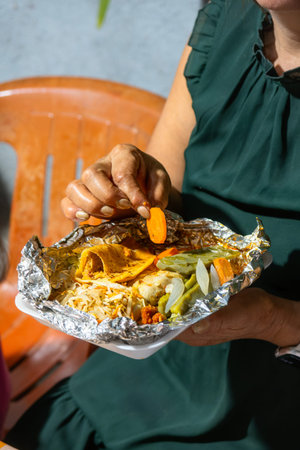 Delicious tacos sudados, a traditional Mexican dish, served with a fresh salad of lettuce, carrots,...