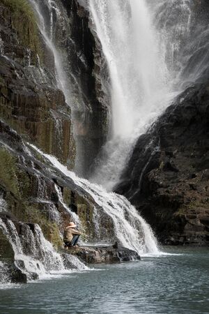Man fishing at Lien Khuong waterfalls in ÄÃ  Láº¡t, Vietnamの写真素材