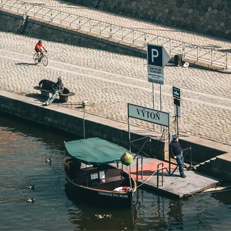 Vyton ferry terminal in Prague. The cyclist, the sailor and the lonely drinker.の写真素材