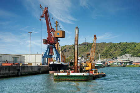 Industrial zone with crane over the water in the Nervion river, Biscay, Basque Country, Euakadi, Euskal Herria, Spain, Europeのeditorial素材