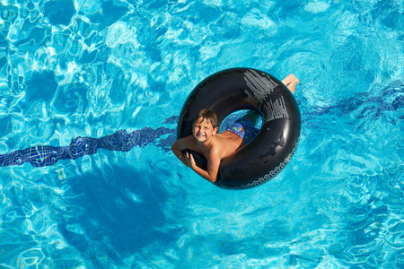 Kid swimming with float smiling