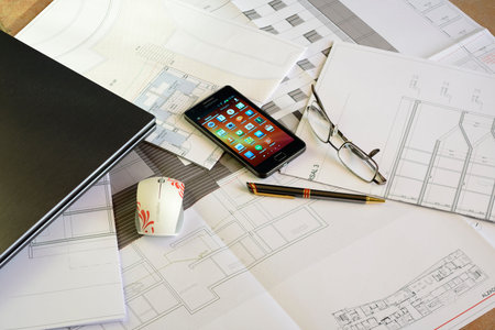Smartphone, glasses, Pen, Laptop and Mouse over Architect plans