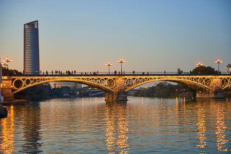 Isabel II bridge or Triana bridge, in Guadalquivir river at Evening, Sevilla, AndalucÃ­a, Spain, Europe.のeditorial素材