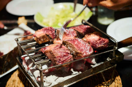 detail of red meat being made on the grillの写真素材