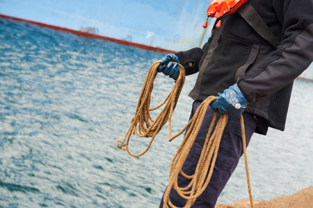 Partial view of the docker with ropes in his hands in the Port of Bilbao, Biscay, Basque Country, Euskadi, Spain, Europeのeditorial素材