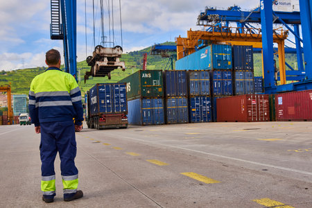 Worker looking the container load, Port of Bilbao, Biscay, Basque Country, Euskadi, Spain, Europe,のeditorial素材