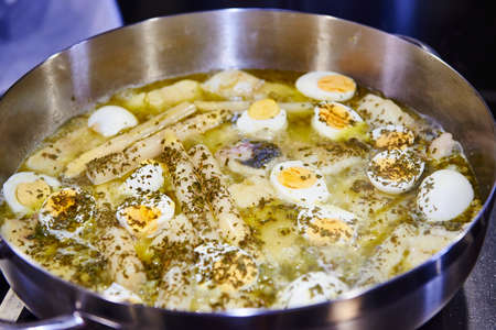 Casserole of hake in a Green Sauce with asparagus and eggsの写真素材