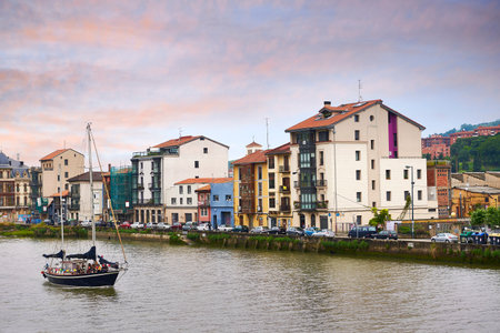 View of the Ria Nervion with a sailboat in the foreground and the Zorrozaurre neighborhood in Bilbao, Bilbao, Biscay, Basque Country, Euskadi, Euskal Herria, Spain, Europeのeditorial素材