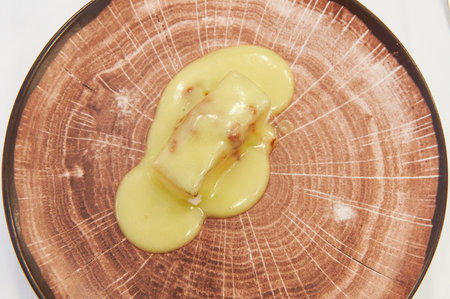 Typical food of the Basque Country Cod al pil pil served on an imitation wood plateの写真素材