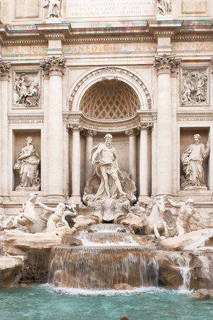 Trevi fountain presenting detailed classical sculptures including oceanus and tritons, with water cascading into the turquoise poolのeditorial素材