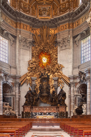 Intricate gilded altar, surrounded by figures and a holy spirit stained glass, standing in a historic European basilica naveのeditorial素材