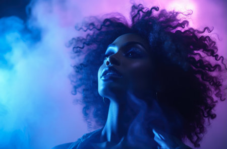 Young African American woman under purple neon lightsの素材