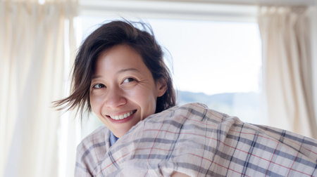 Young Asian woman enjoying the comfort of her homeの素材