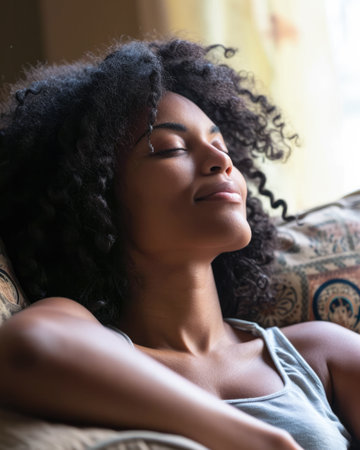 Young African American woman relaxing at homeの素材