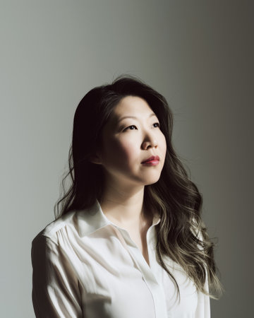 Seasoned Asian businesswoman portrait looking confident on a color copy space backgroundの素材