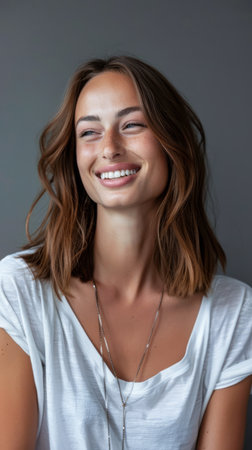 Portrait of a smiling young woman looking at the camera with a copy space backgroundの素材