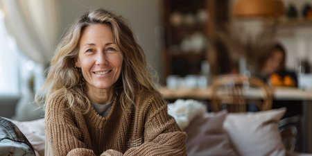Portrait of a young beautiful woman at home wearing a cozy knitwearの素材