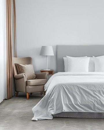 Modern hotel room with elegant bedding and stylish decor. Neutral tones and use of natural light.の素材