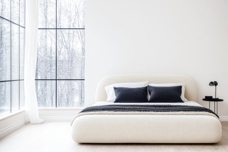 Bedroom interiors with an elegant bed next to a window and minimalist furniture. Residential spaces for relaxing composition with copyspace.の素材