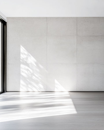 Empty room interiors in neutral tones with a mix of natural window lighting and shadows. Property interior with no furniture or decor.の素材