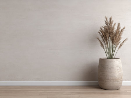 A neutral-colored room showcases a beige vase containing pampas grass, set against a smooth wall and complemented by wooden flooring, creating a serene atmosphere.の素材