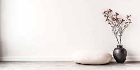 A minimalist living area showcases a round cushion and a simple vase with branches, creating a calm and inviting atmosphere in the softly lit room.の素材