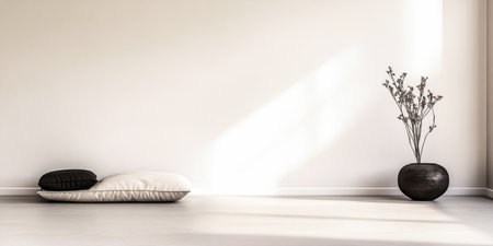A tranquil room showcases two floor cushions in neutral tones, complemented by a simple vase with dried flowers, all bathed in soft sunlight for a peaceful ambiance.の素材