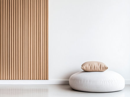 A spacious room showcases a textured beige wall and a soft round cushion with a neutral pillow placed on it, emphasizing minimalist aesthetics and tranquility.の素材
