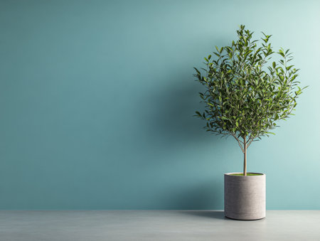 A lush green indoor plant thrives in a sleek gray pot, positioned against a refreshing turquoise wall. The setting is bright and inviting, perfect for enhancing any interior space.の素材