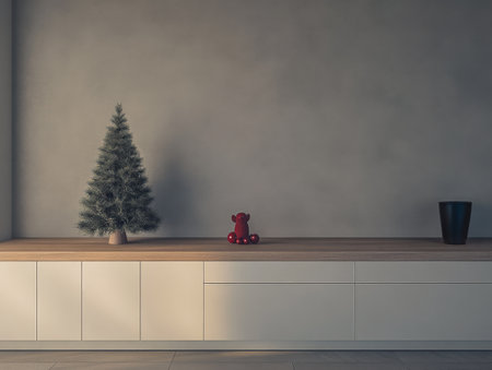 A cozy indoor space features a small Christmas tree on a wooden bench, accompanied by a decorative bear and a sleek vase. The neutral walls enhance the festive atmosphere.の素材