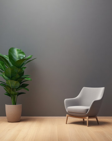 A peaceful interior setup highlights a sleek grey armchair positioned beside a tall indoor plant in a decorative pot, all set against a soft grey wall and smooth wooden flooring.の素材