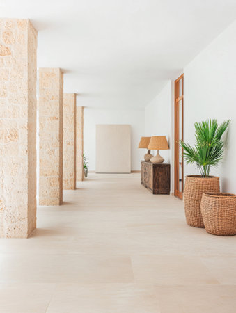 A spacious hallway features elegant columns, warm lighting, and natural elements like plants and wood furniture, creating a calm and inviting atmosphere in a contemporary setting.の素材