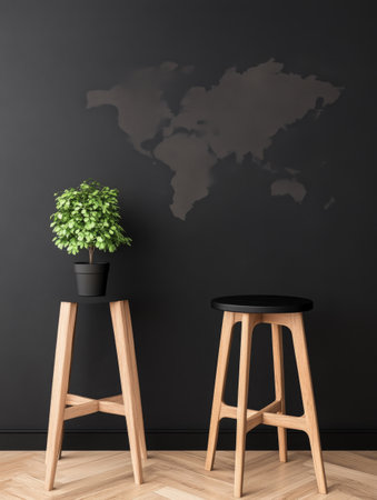 This modern interior showcases two wooden stools beside a black wall adorned with a world map design. A lush green plant in a pot adds a touch of nature to the contemporary space.の素材