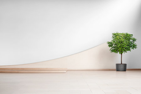 A minimalist interior showcases a sleek curved wall design with a potted plant, creating a serene environment. The light wooden flooring enhances the modern aesthetic.の素材