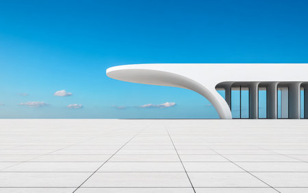 A sleek white building features a curved overhang, set against a clear blue sky. The surrounding area consists of large square tiles, emphasizing the modern design and minimalism.の素材