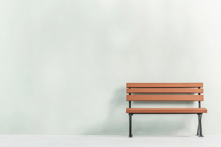 A simple wooden bench is placed against a light-colored wall in a minimalist interior. The setting emphasizes the clean lines and calm atmosphere.の素材
