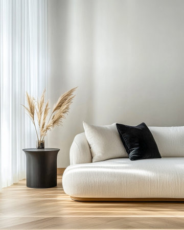 A modern living room showcases a plush, curved sofa adorned with black and white cushions.の素材