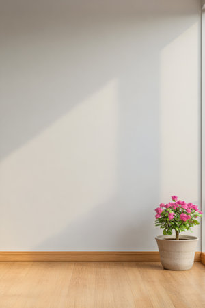 A flowering plant sits in a pot on the wooden floor, brightened by afternoon sunlight streaming through the window, creating a warm and tranquil atmosphere in the room's corner.の素材