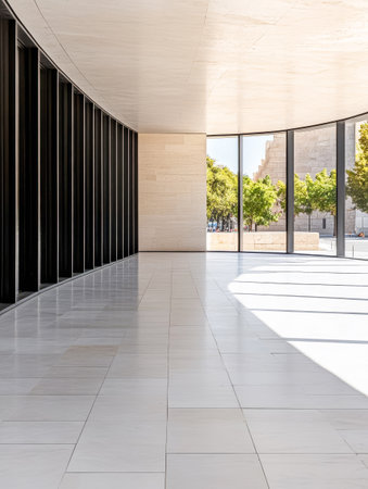 A bright and spacious interior boasts a smooth, tiled floor with curved walls and tall windows. Natural light floods the area, illuminating views of greenery outside, creating a serene atmosphere.の素材