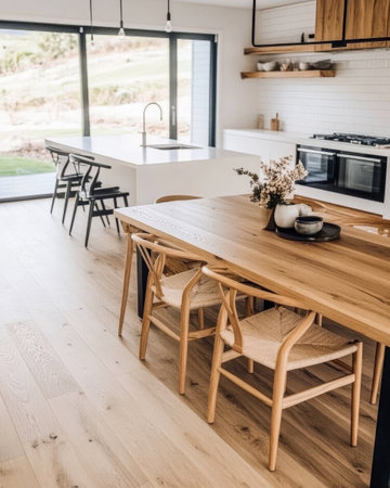 A stylish, contemporary kitchen and dining area showcases a wooden table with chairs, large windows allowing natural light, and a well-equipped cooking space.の素材