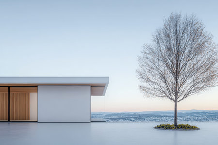 A minimalist house features large windows and clean lines next to a solitary tree. The setting sun casts a warm glow over the landscape enhancing the serene ambiance of the surroundings.の素材