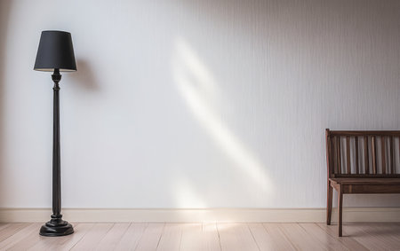 A minimalist interior showcases a tall black floor lamp beside a simple wooden bench against a light-colored wall. Soft light filters in creating a serene atmosphere.の素材