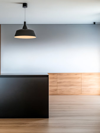 A stylish reception area showcases a black desk under a pendant light with a warm wooden backdrop. The minimalist design emphasizes clean lines and an uncluttered atmosphere.の素材