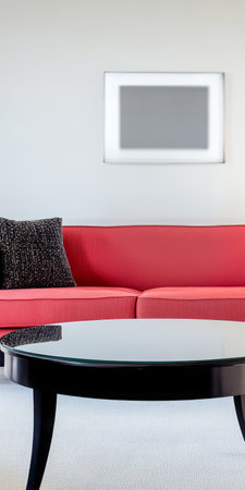 A modern living room showcases a vibrant red couch paired with a sleek black coffee table. The minimalist decor emphasizes comfort and style in an inviting atmosphere.の素材