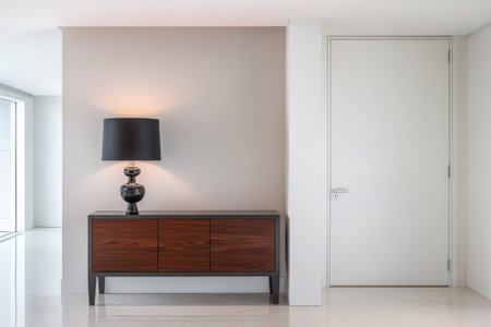 A contemporary hallway features a sleek wooden console table with four drawers adorned by an elegant black lamp. The clean lines and neutral colors create a calm atmosphere emphasizing minimalism.の素材