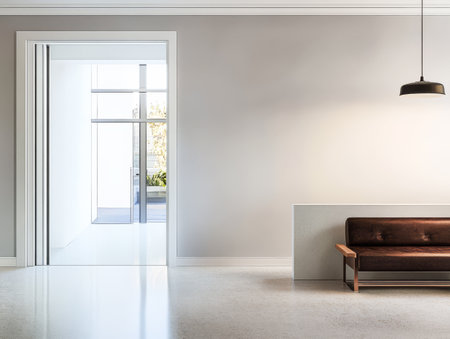 A minimalist living space showcases a brown leather sofa against a light-colored wall with large glass doors allowing natural light to fill the room.の素材