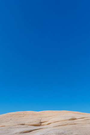 Clear skies dominate the landscape highlighting the smooth sandy surface below. The scene radiates tranquility and warmth inviting exploration and reflection in nature.の素材