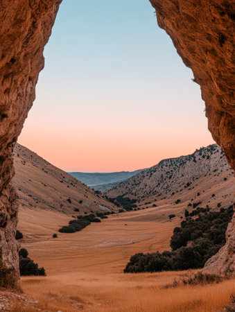 A breathtaking view of a wide valley is visible through rock formations.の素材
