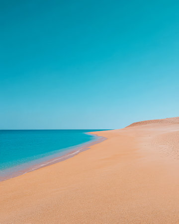 A pristine sandy beach stretches along the shore meeting the calm turquoise water. A clear blue sky complements the serene landscape creating a perfect spot for relaxation.の素材