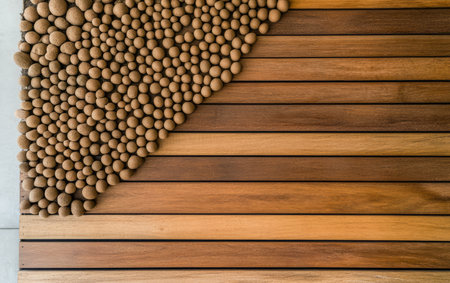 A beautifully crafted wooden surface is enhanced by a unique arrangement of pebbles. The natural textures blend harmoniously showcasing artistry in design and craftsmanship.の素材